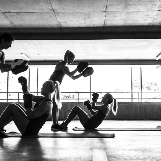 Group of women sport team boxing outdoor inside a multi level parking in Australia.