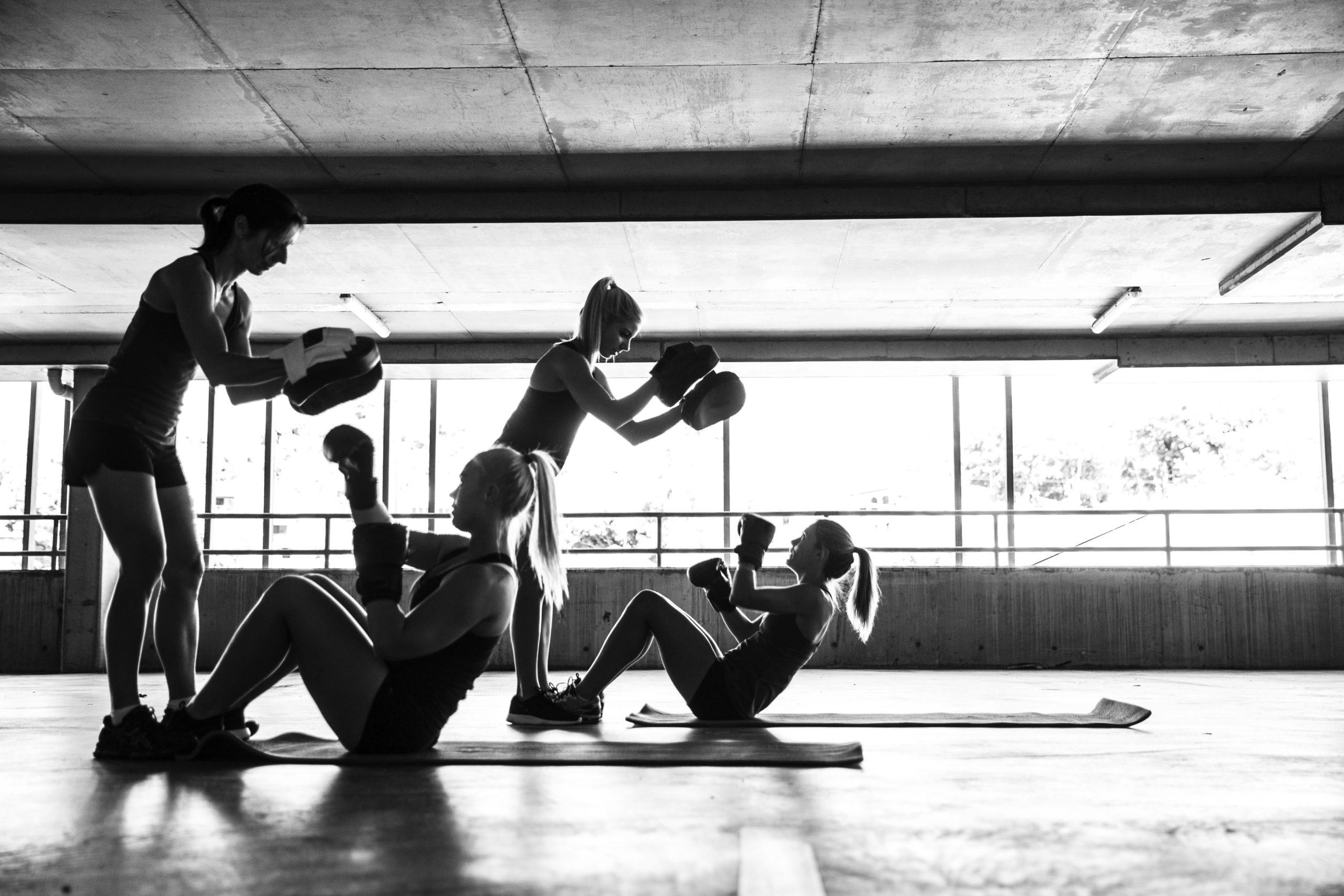 Group of women sport team boxing outdoor inside a multi level parking in Australia.