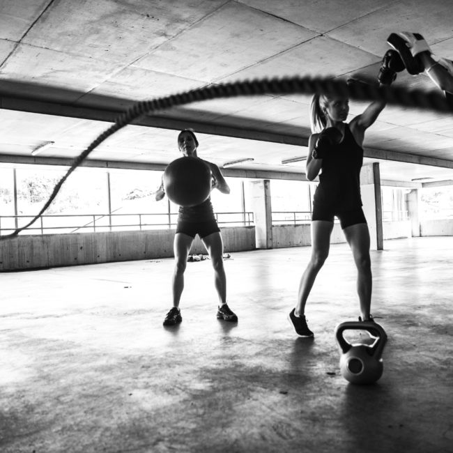 Group of women training on rope and boxing inside an multi level parking in Australia.