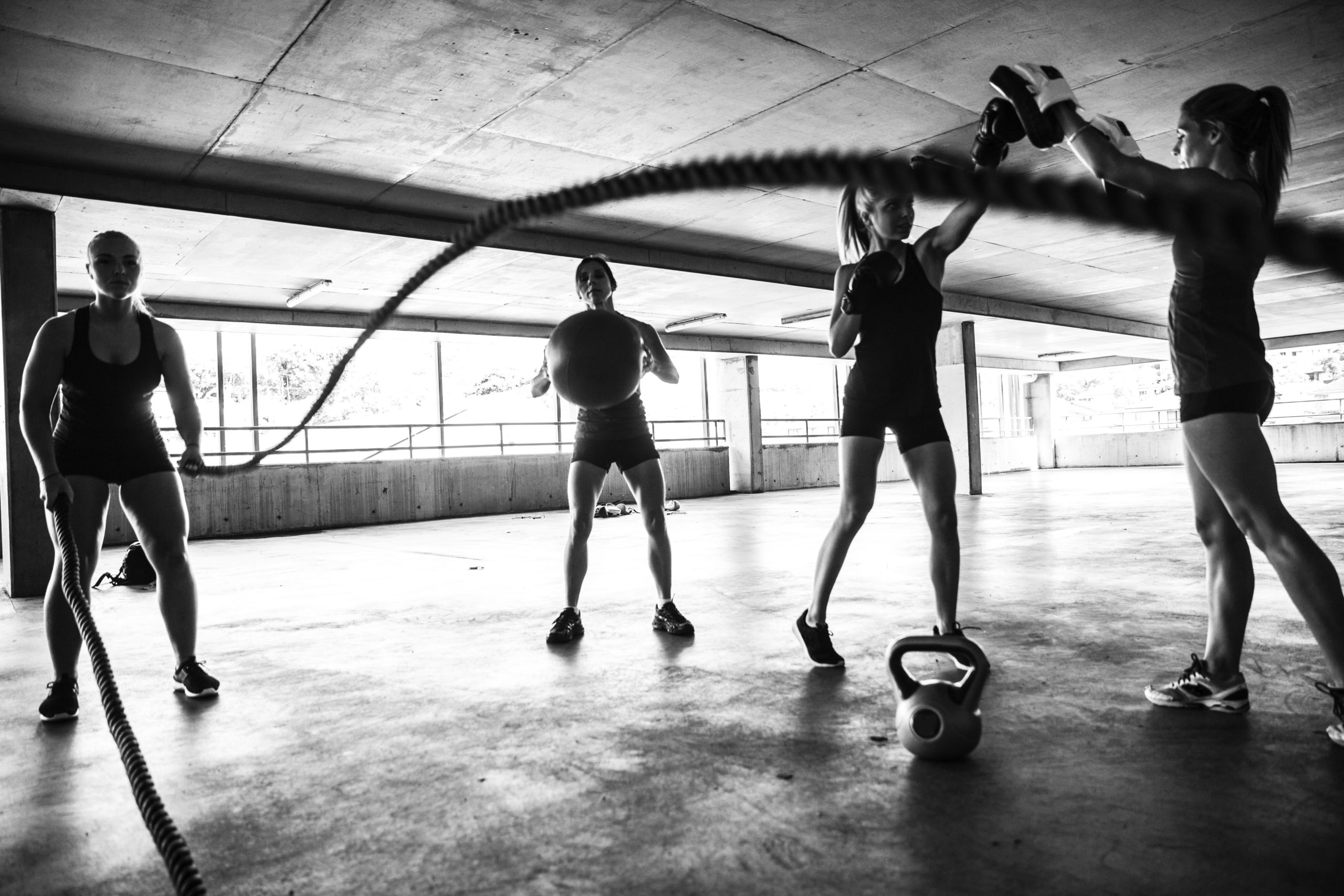 Group of women training on rope and boxing inside an multi level parking in Australia.