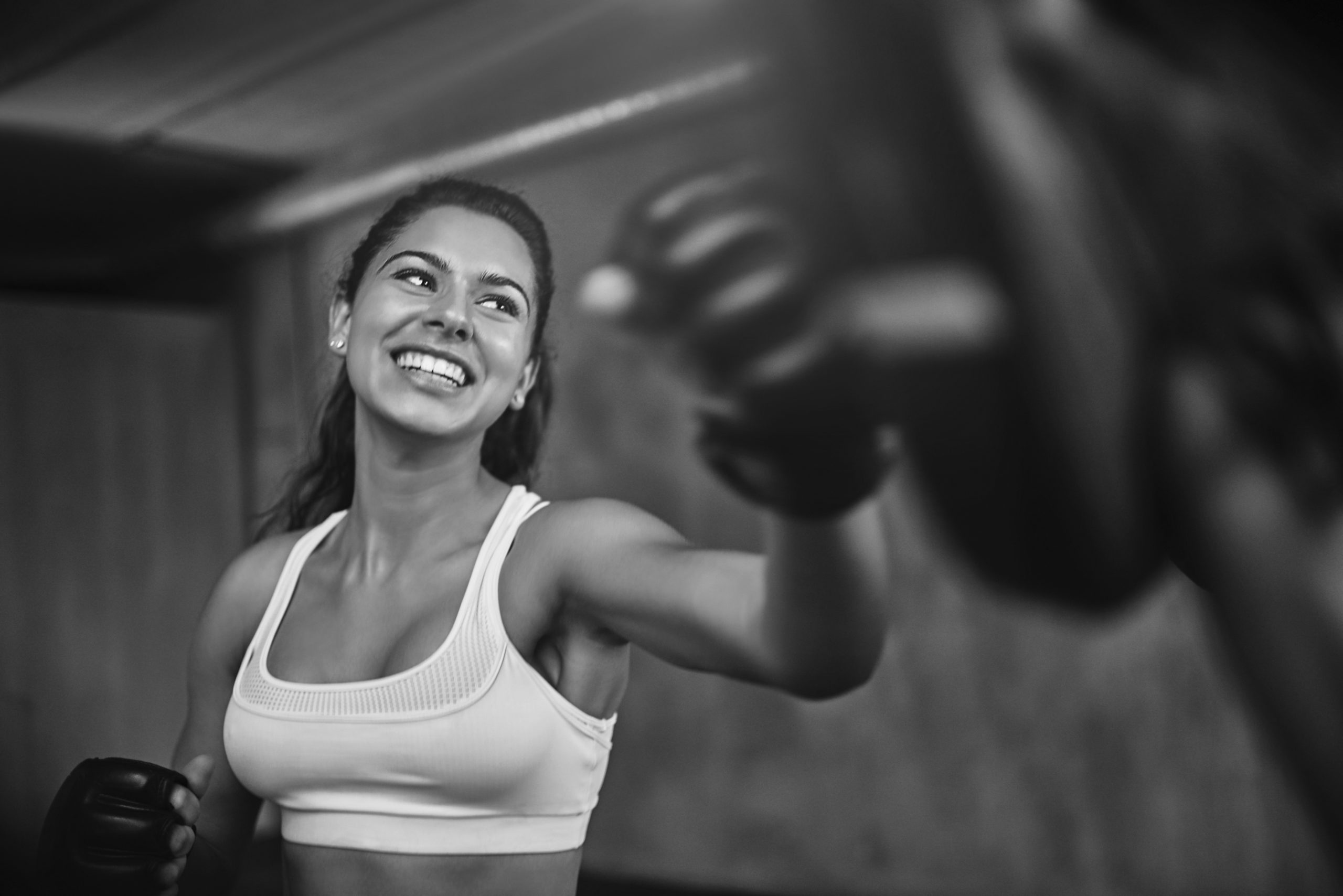 Shot of a young woman sparring with a boxing partner at the gym